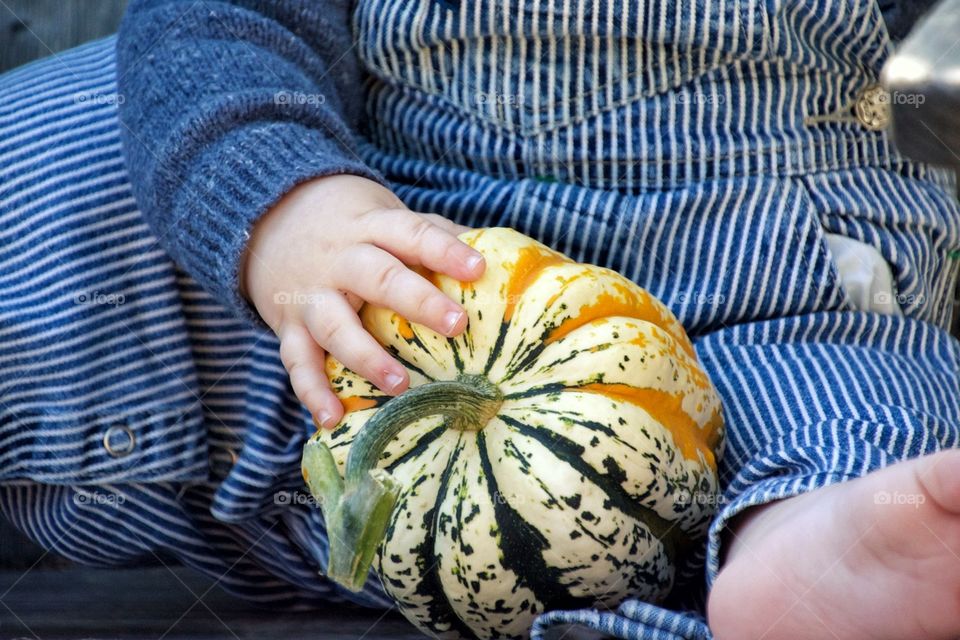Baby holding a squash