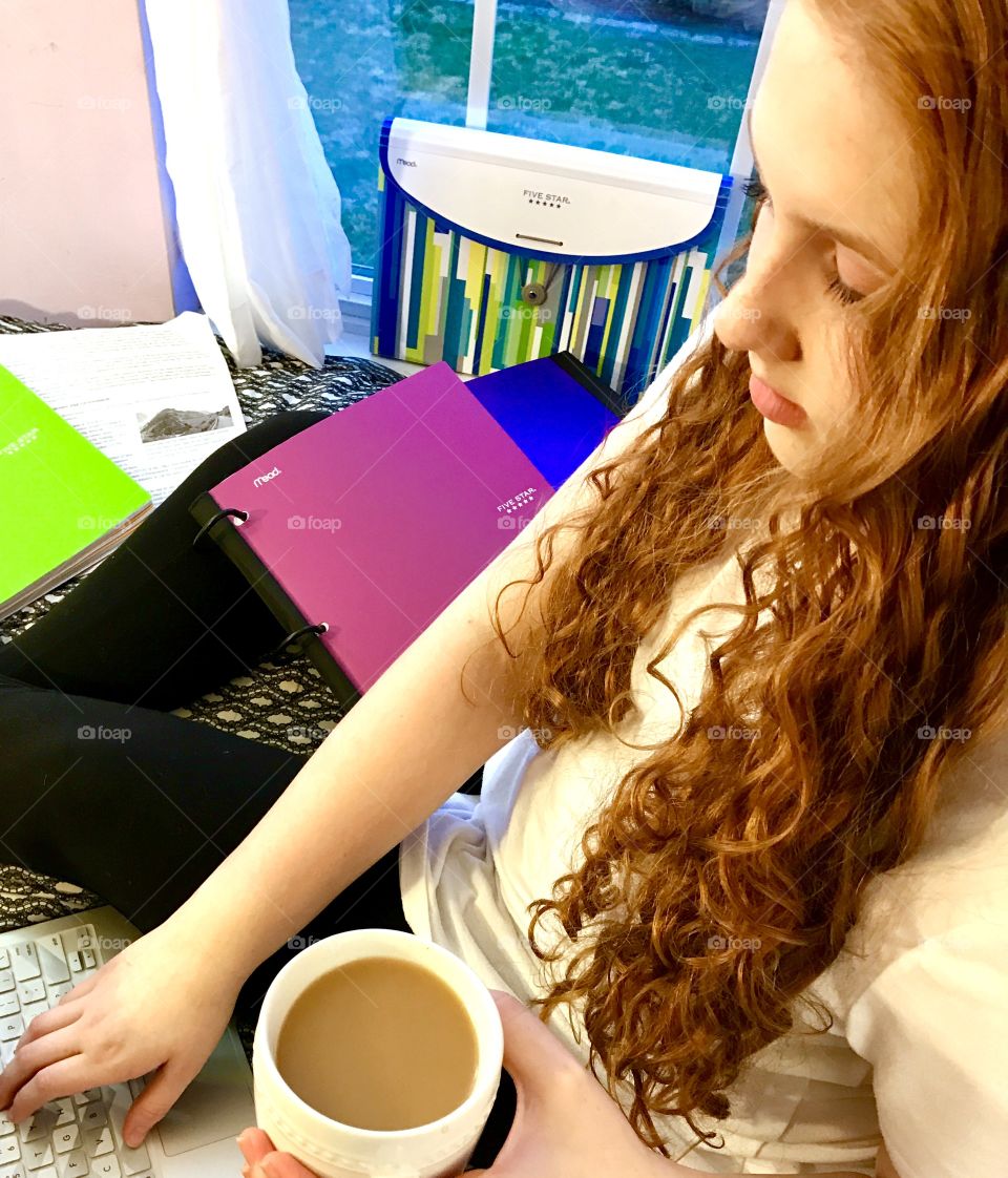 Girl studying by Window