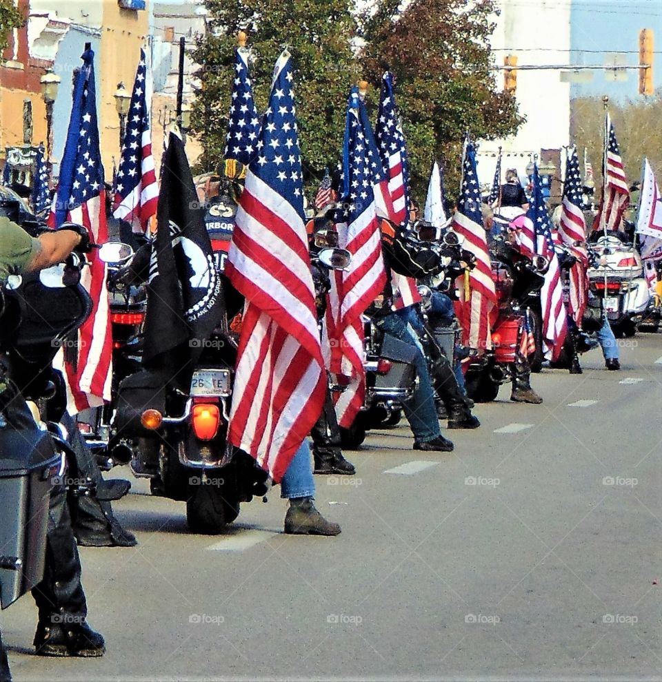 Veteran soldiers​ ride with all American pride, flying the red, white and blue, as well as the P.O.W and M.I.A. flags. The respect and brotherhood rumbled louder than the bikers motorcycles as they cruised through  Midwestern USA. This proud display was captured in Ottawa, Kansas.