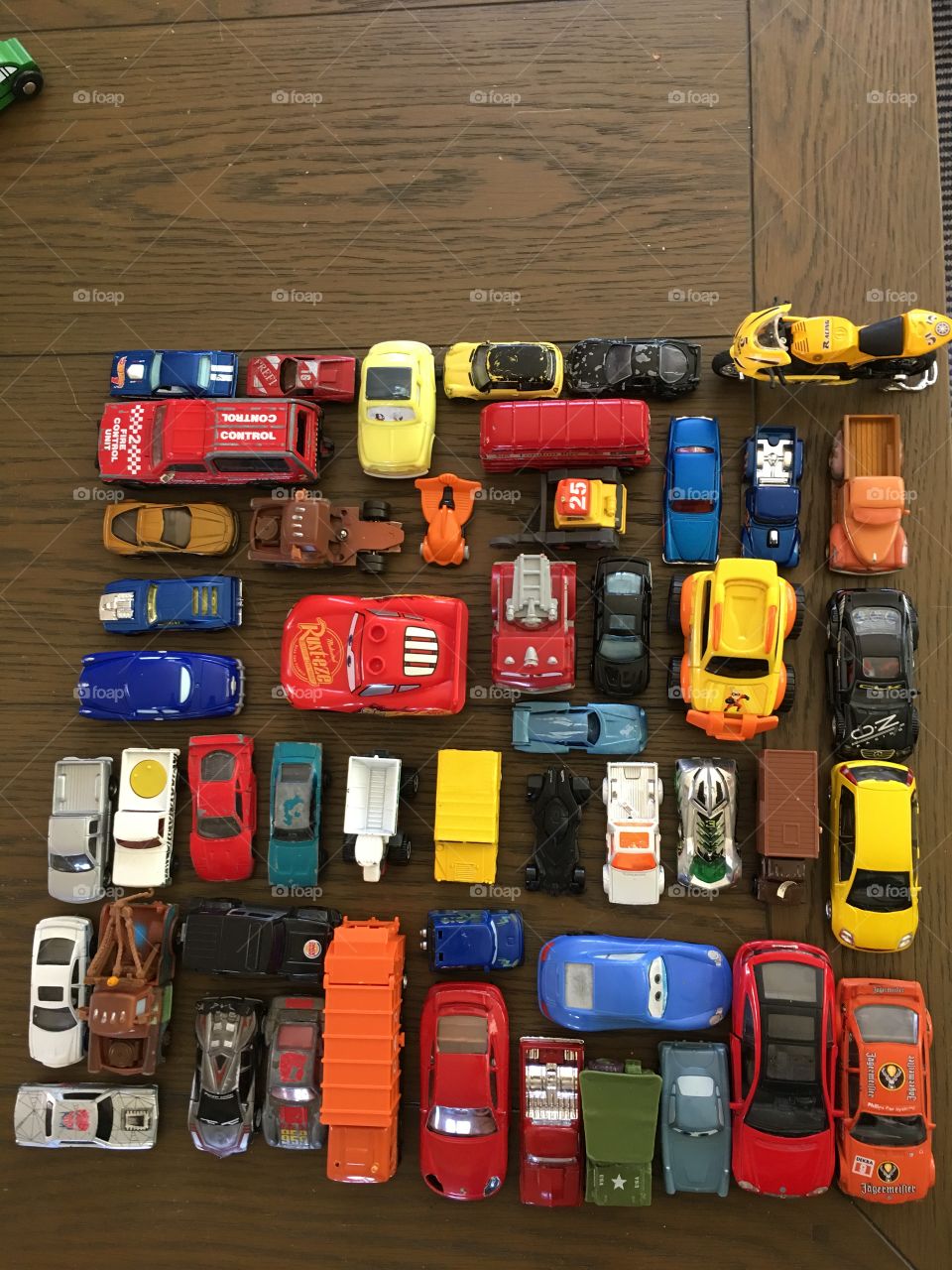 Toy cars arranged into a colorful array