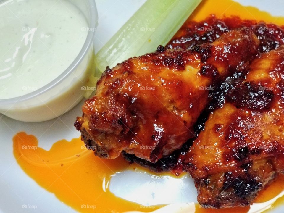 Medium chicken wing cooked than pan fried with butter and BBQ sauce.. served with blue cheese and celery