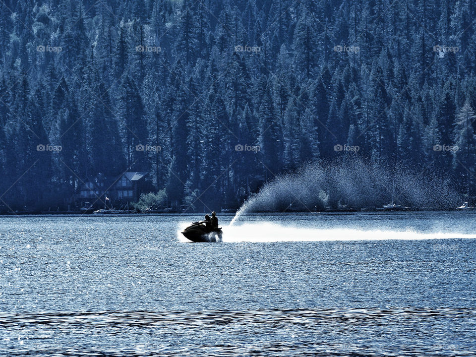 Jet ski with rooster tail on a lake