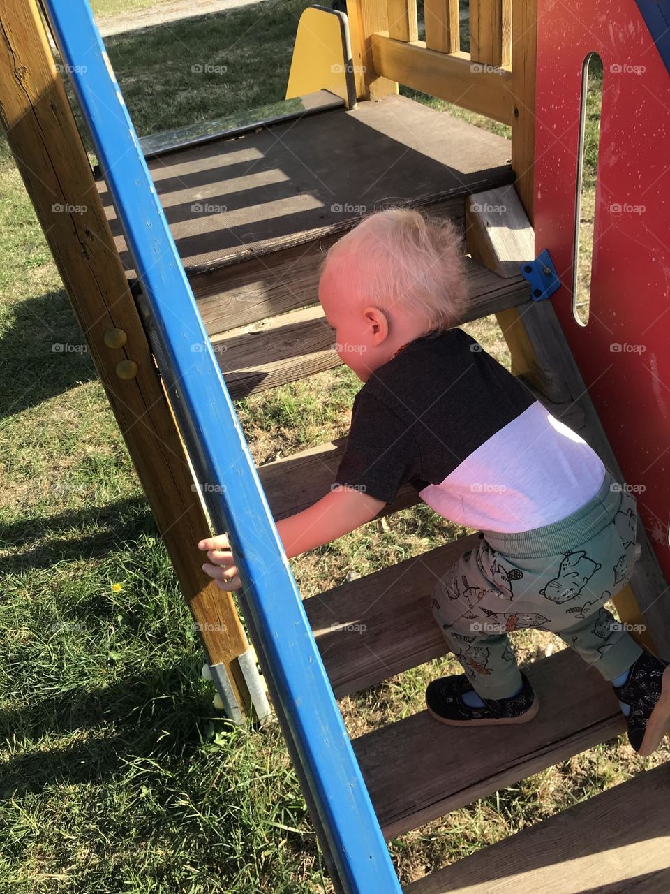 a little boy with blond hair is playing in the kindergarten