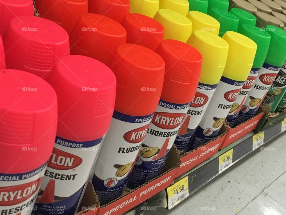 Krylon neon spray paint cans on store shelf. 