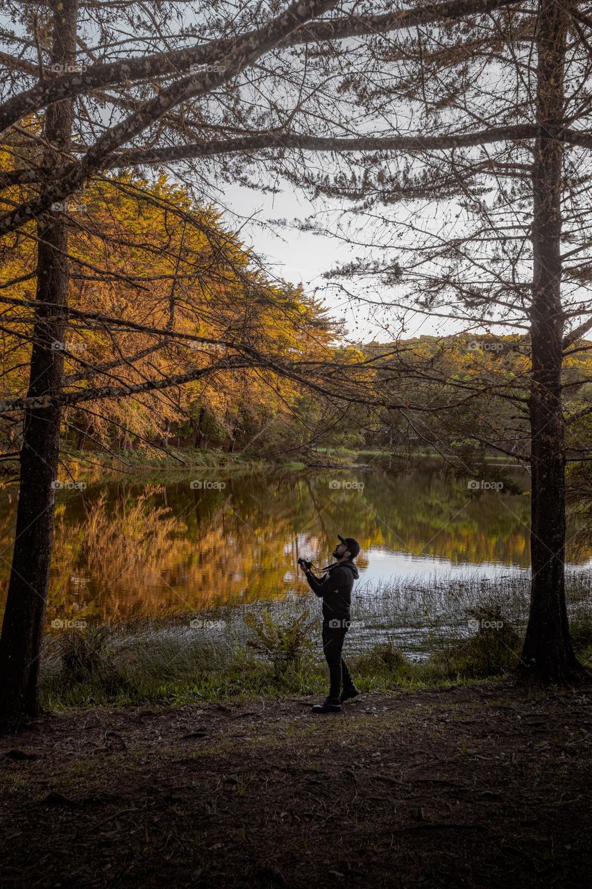 Photographer photographing the beutiful lake in the golden hour
