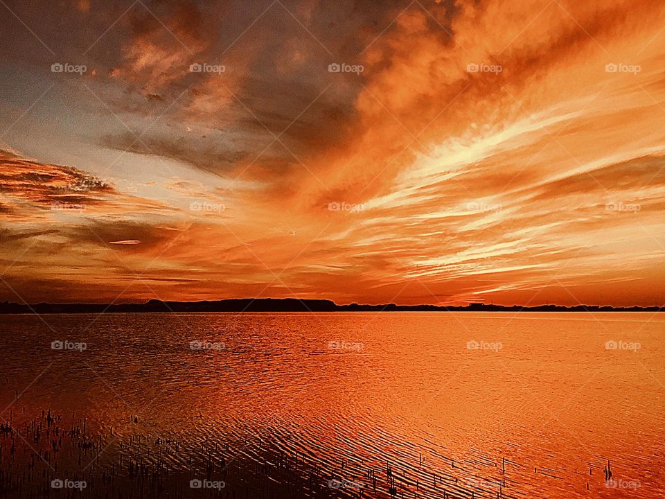 Crepuscular rays over the water - Shafts of light which are seen just after the sun has set and which extend over the western sky radiating from the position of the sun below the horizon