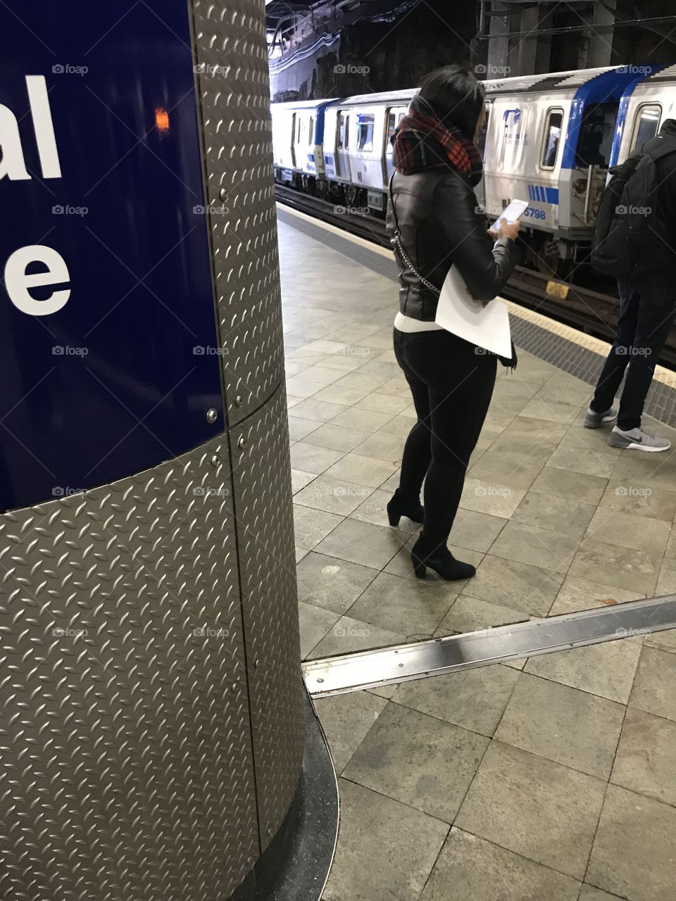 Pretty girl texting while she waits for the WTC PATH train at Journal Square.
