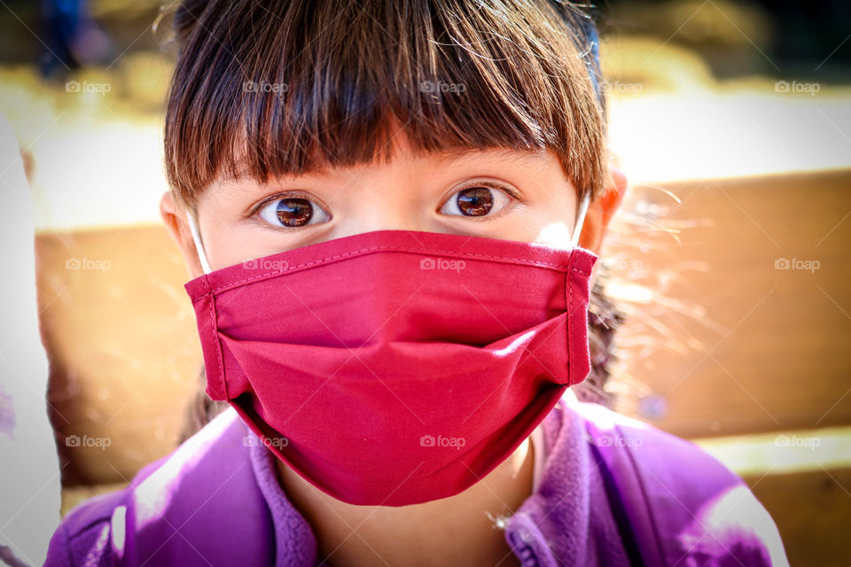 Little girl in a face mask