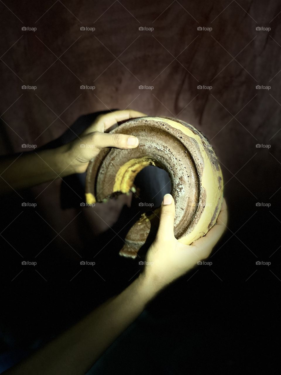 My sister holds the cake in her two hands and wants me to take a picture of it