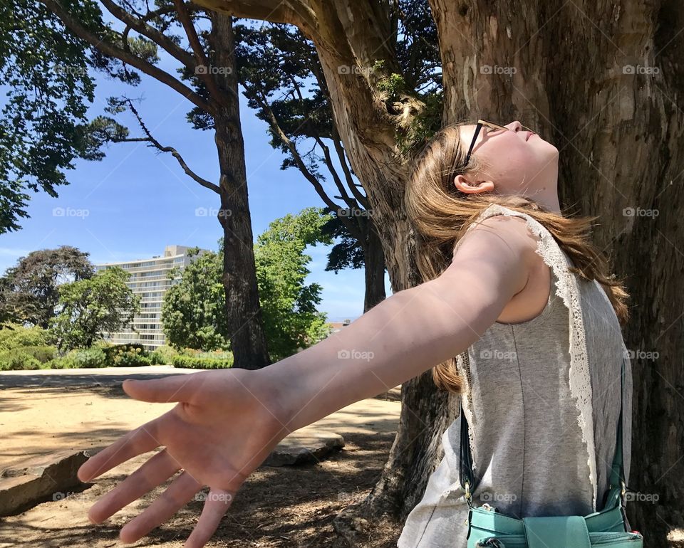 Close-up of a girl standing under tree