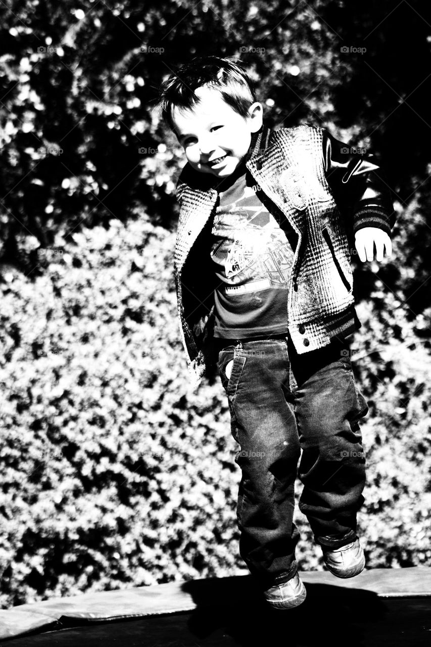 silhouette of a kid on a trampoline