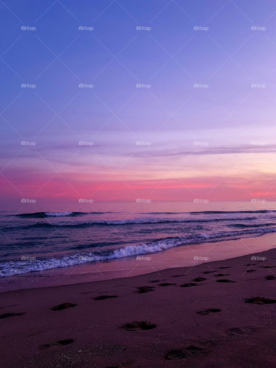 Landscape of a beach during pink sunset in summer 
