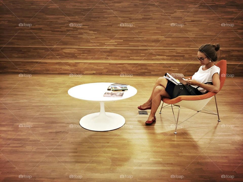 Girl reading in a comfortable chair