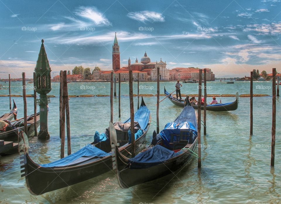 Gondolier at the Piazza San Marco. Gondolier bringing his passengers back to Piazza San Marco