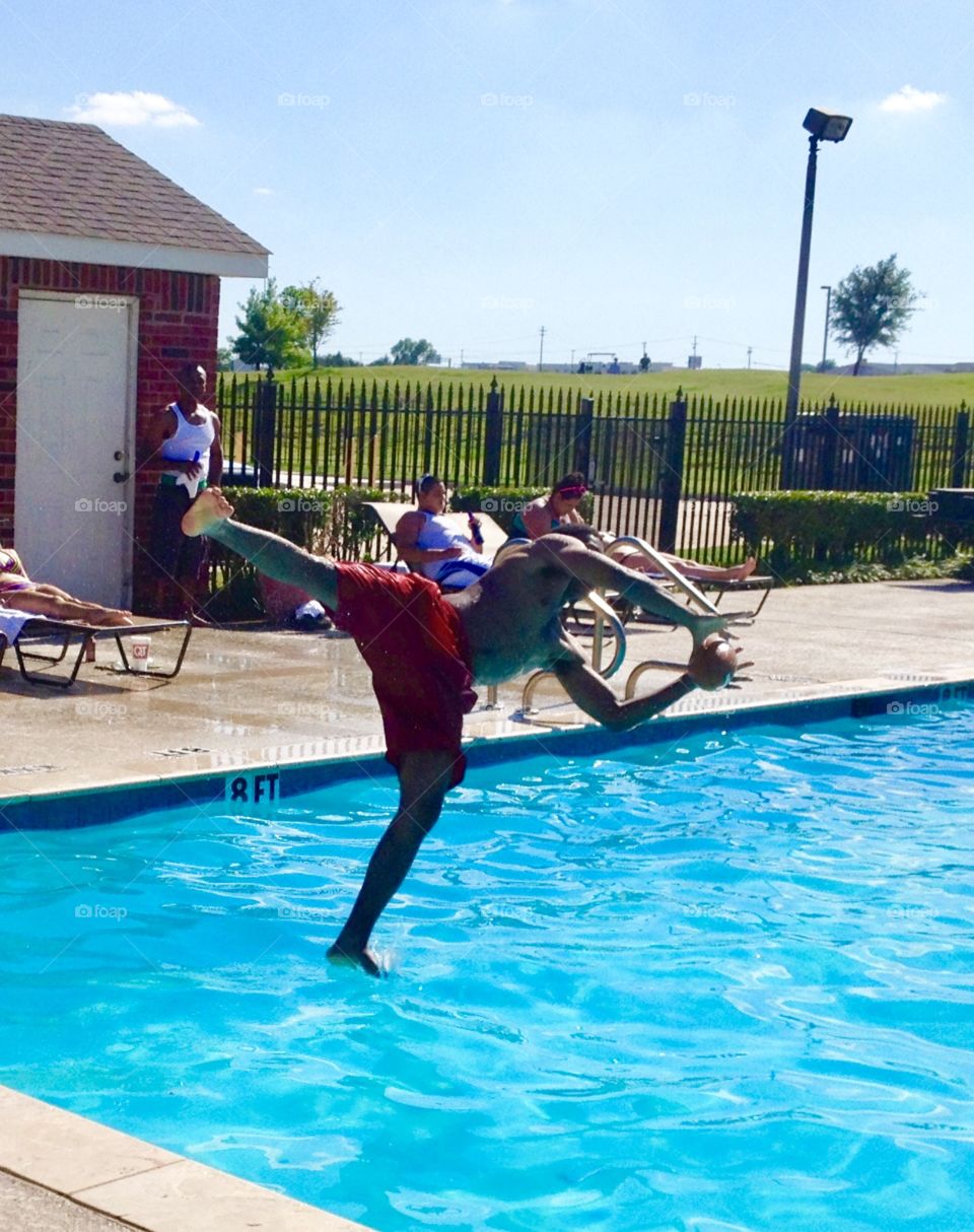 Catching the football in midair at the apartment pool, McKinney Texas, beating the heat, “good catch”