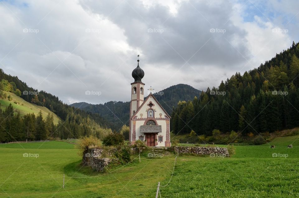 Church of st. Johann Val di Funes. Church of st. Johann Val di Funes green hill and mountains background