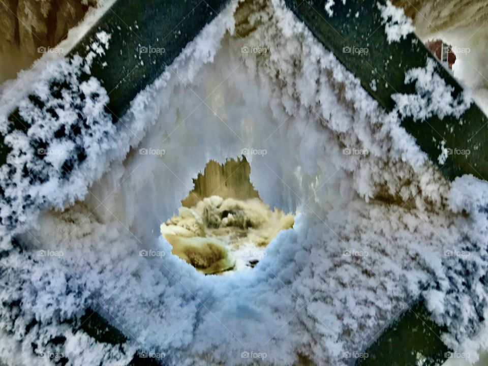 Peak to rapids from a frozen hole in bridge.