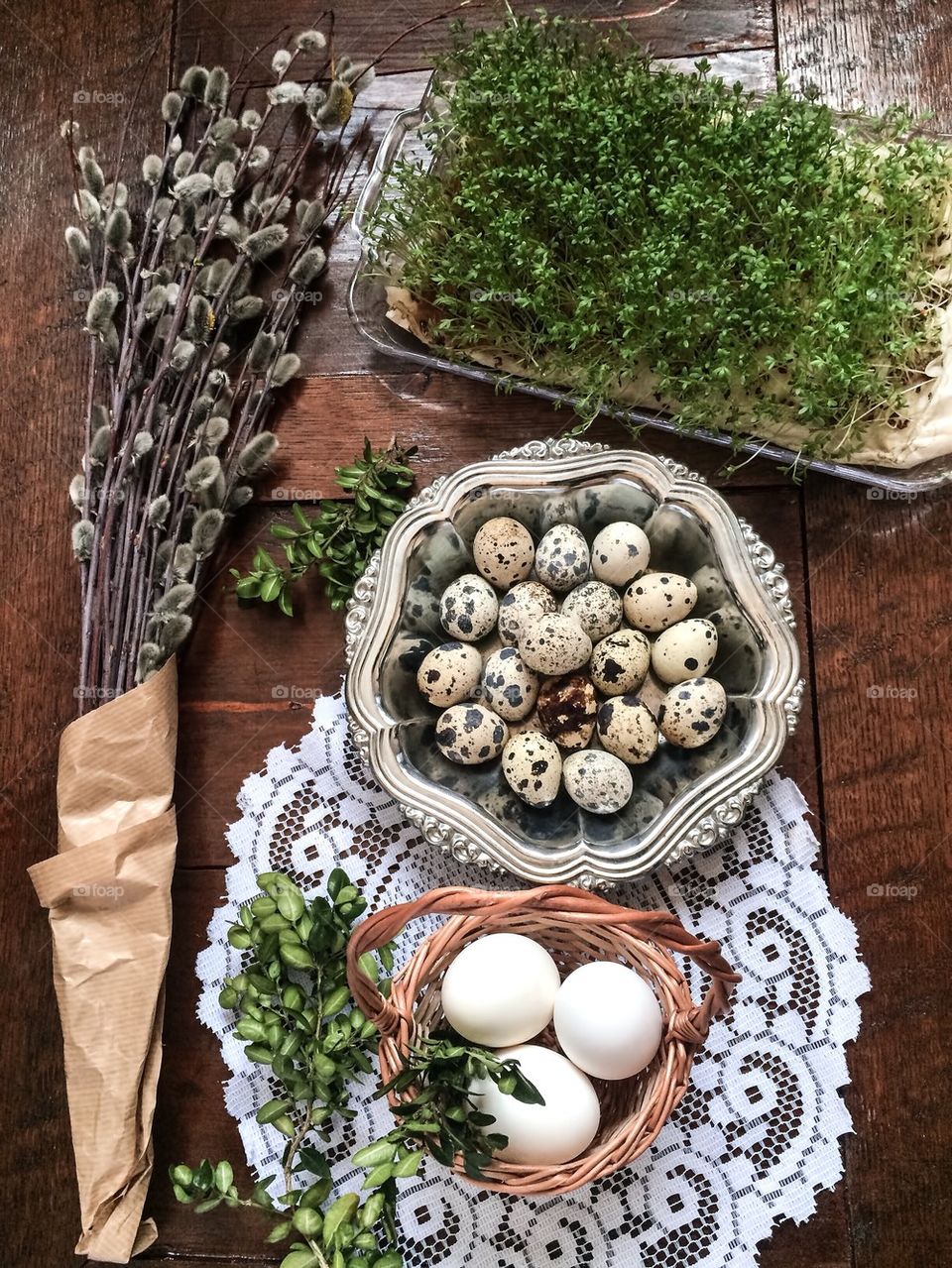 Easter composition of catkins, eggs and cress on wooden table