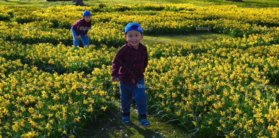 Twins Enjoying Spring Weather With Spring Flowers