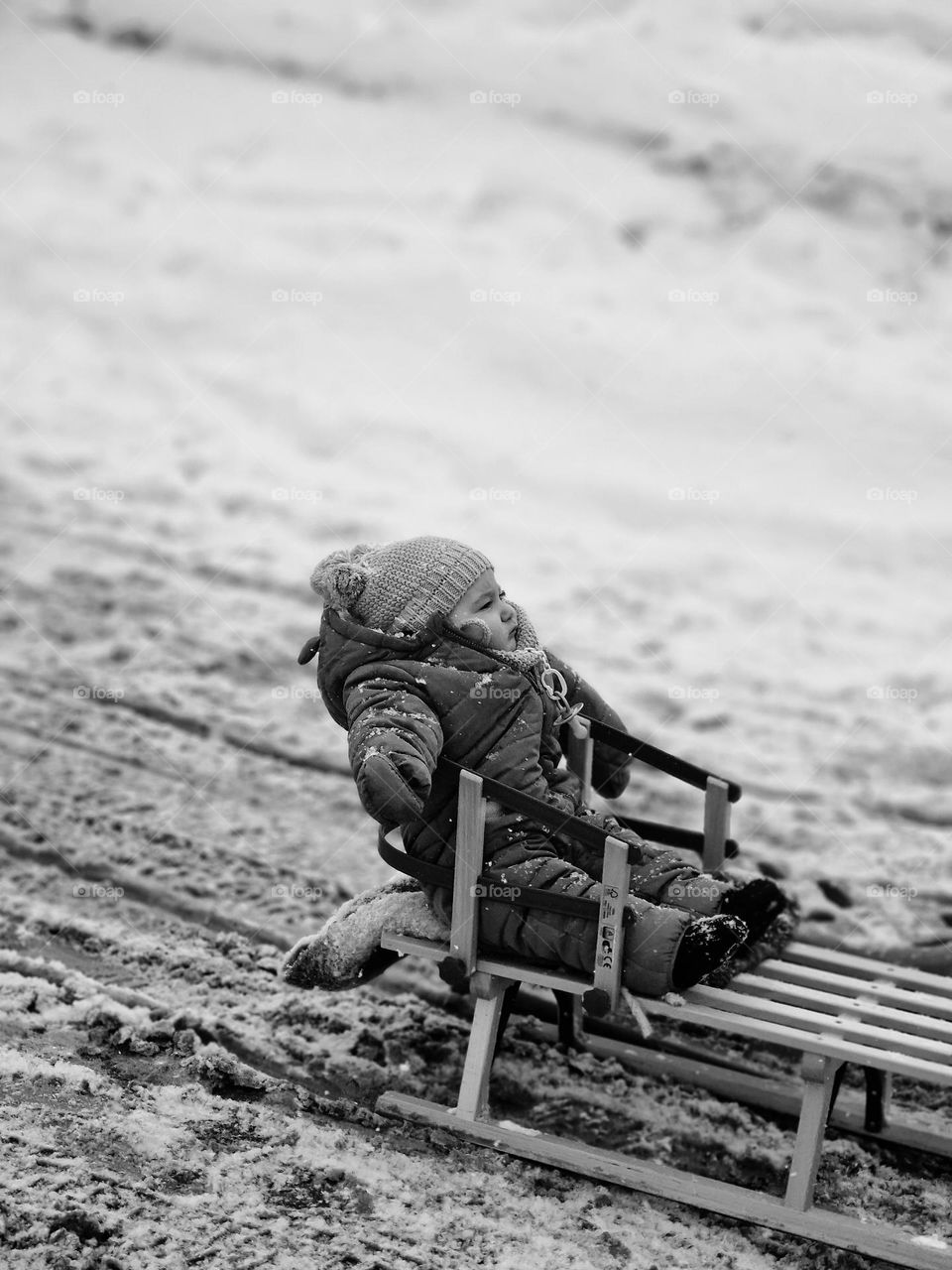 sled baby in black and white