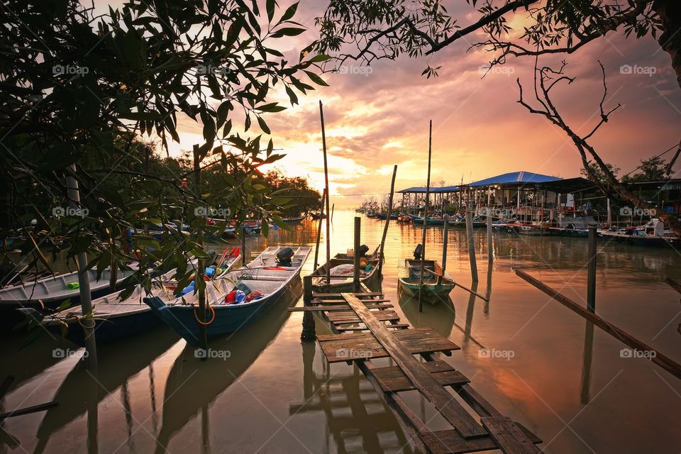 Boat and sunset reflections