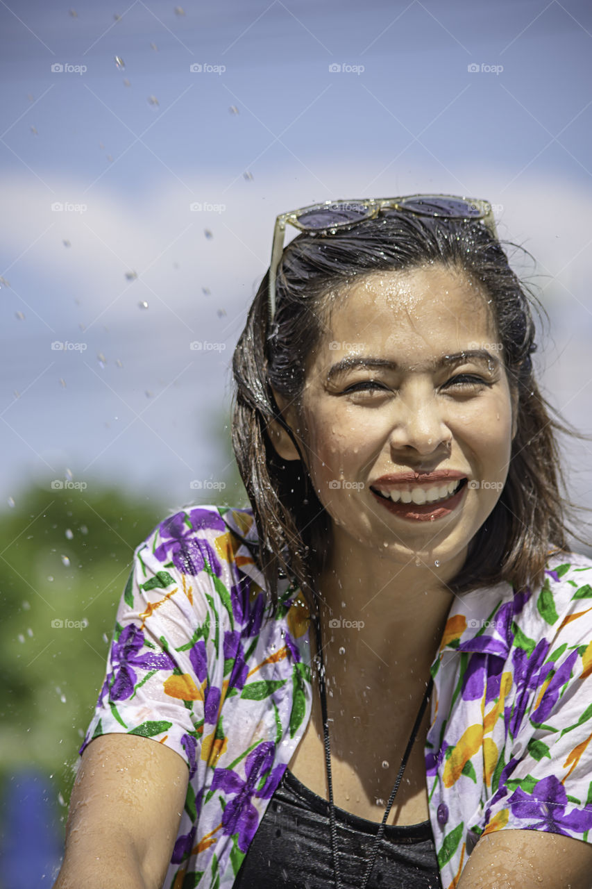 Asian woman play water in Songkran festival or Thai new year in Thailand.