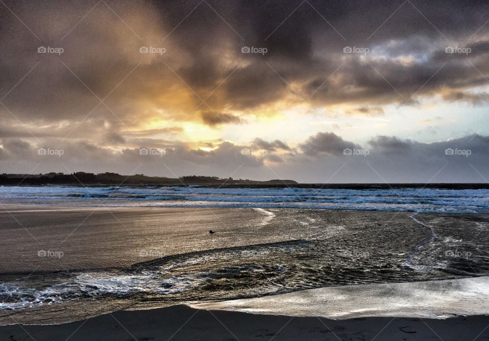 Scenic view of sea against dramatic sky