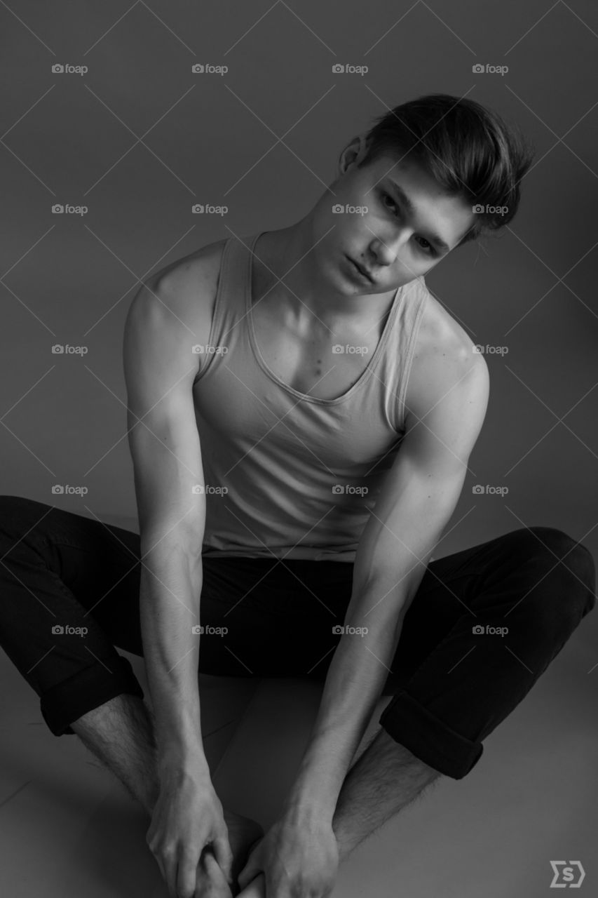 the guy is sitting on the floor