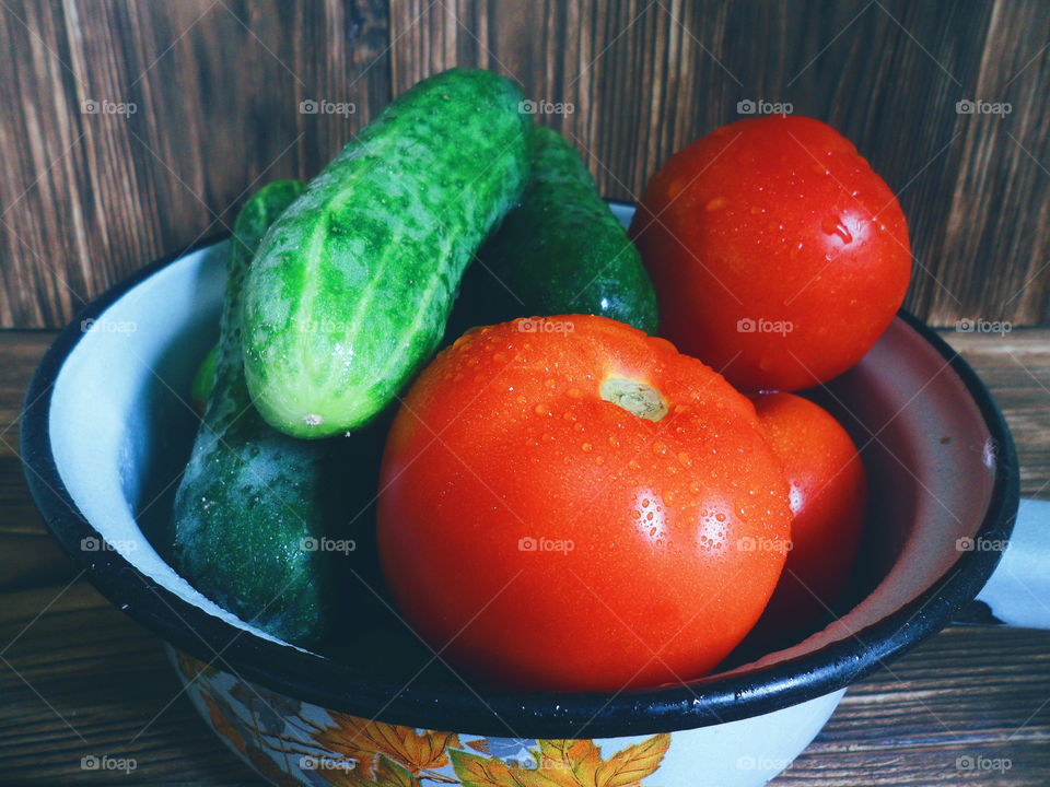 vegetables red tomatoes and cucumbers in a bowl