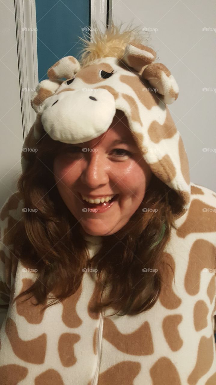 Getting snuggly and smiley in a giraffe onesie.