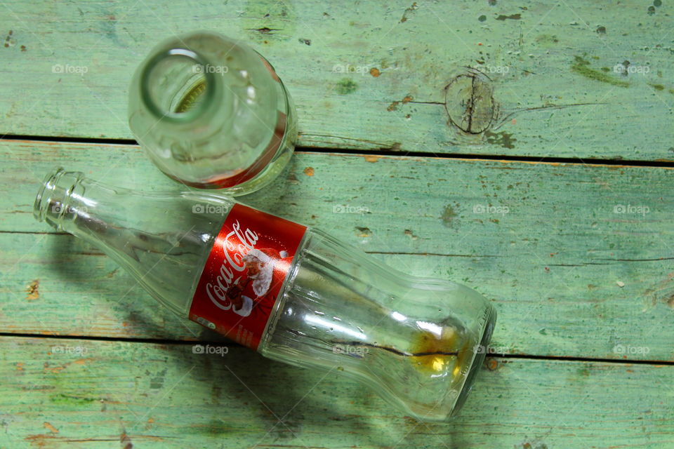 bottles of Coca cola on a wooden table