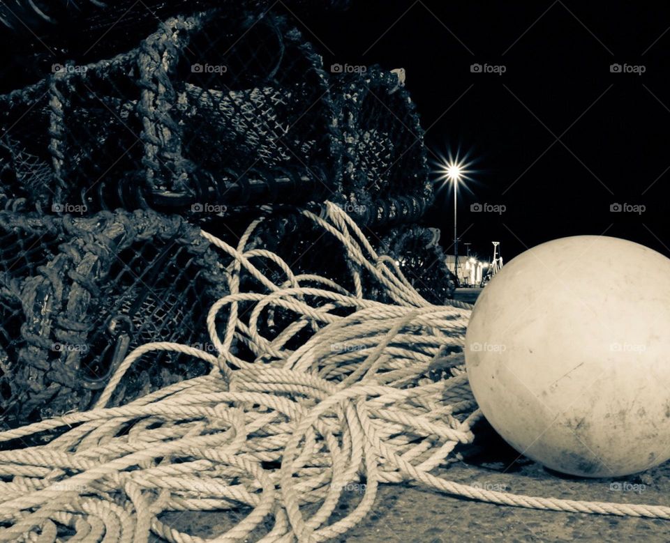 Black and white fisherman’s traps, ropes and traps by the ocean, seaside fisherman’s gear, nighttime traps for fishing 