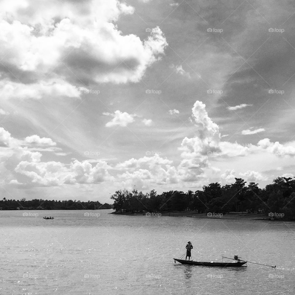 Black and white shot: fisherman on the boat
