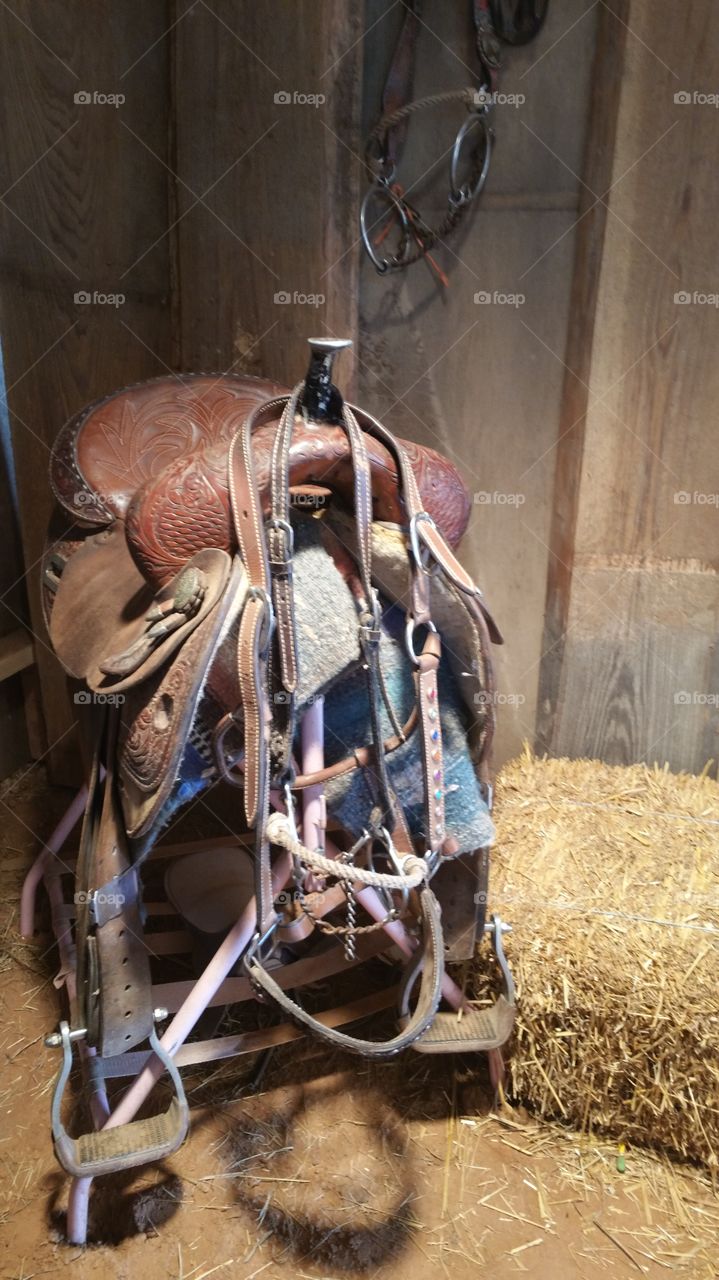 Leather saddle in stable