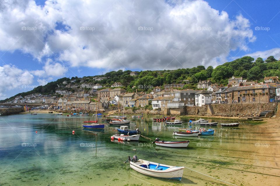 The small Cornish fishing village and harbour of Mousehole in  
Cornwall on a sunny day.