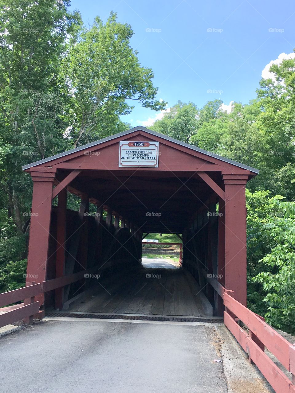 Summer view of covered bridge over water