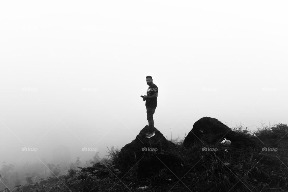 cloudy morning man standing on the rock