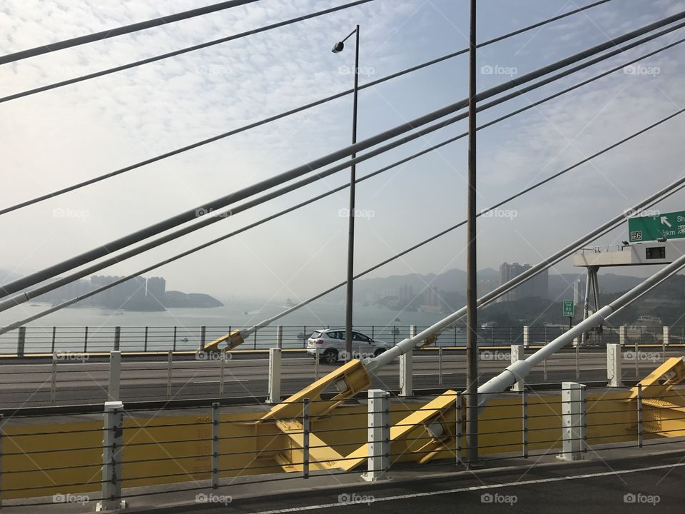 Hong Kong bridge to airport, buses, cars on the road, sea, high way 