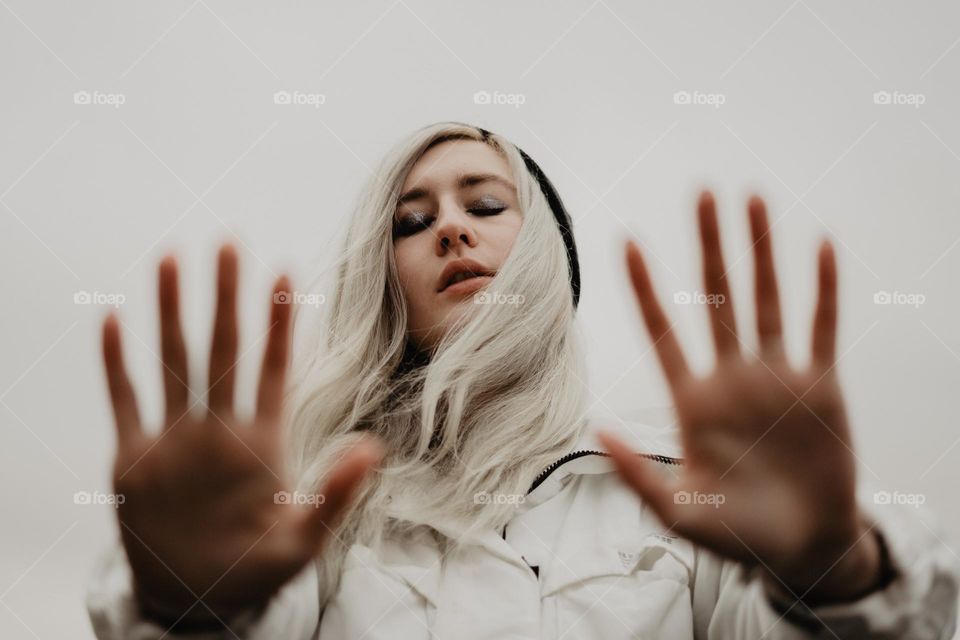 blurred hands unfocused, blond girl in autumn, eyes closed, beautiful portrait 