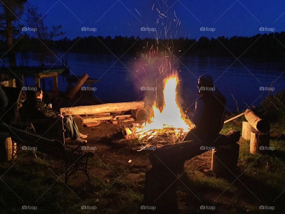 Friends by the fire. Friends chatting by the fire