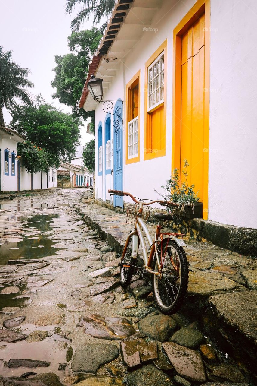 Lonely Bicycle on a rocky Brazilian Street, at Paraty, Rio de Janeiro. Vintage Bike on a Rainy day