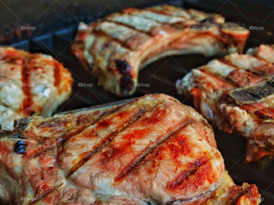 Grilling Pork Chops. Tender Pork Chops Cooking On A Grill
