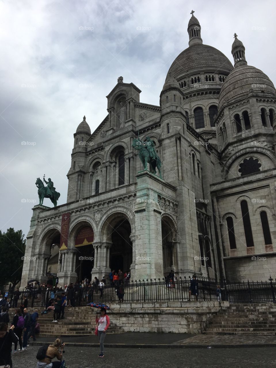 The Basilica of the Sacred Heart of Paris, or Sacré-Cœur, on a rainy day in Paris, France. 