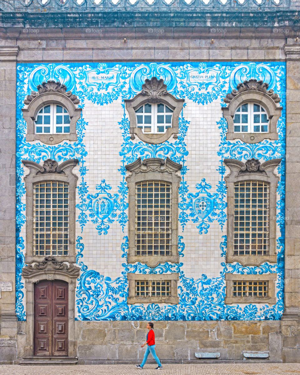 Girl standing against traditional Portuguese tile wall