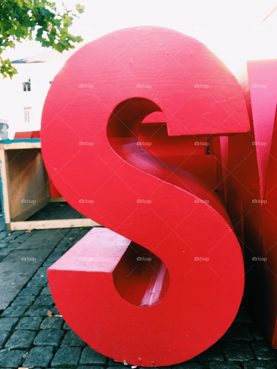 The letter S in red