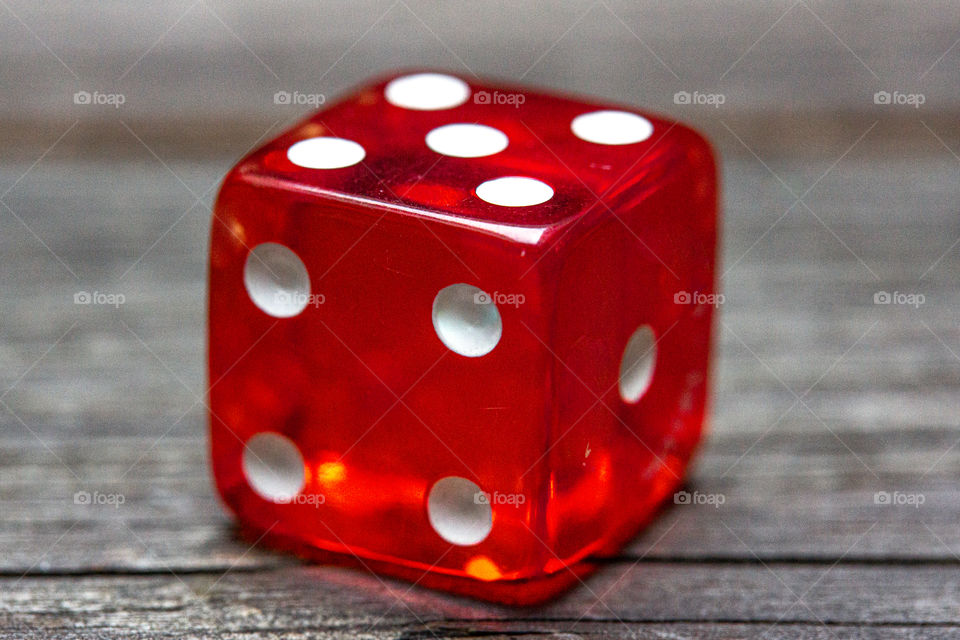 close-up of a red dice and white points