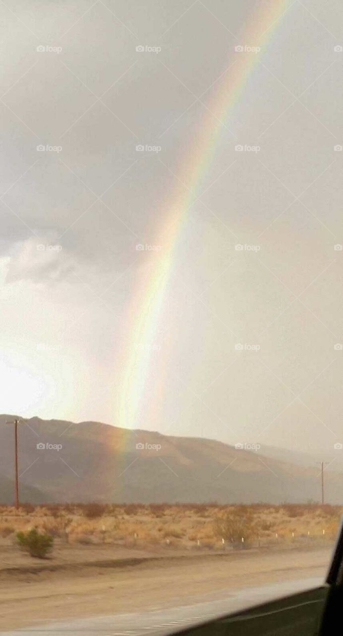 a photo of a beautiful rainbow in the desert
