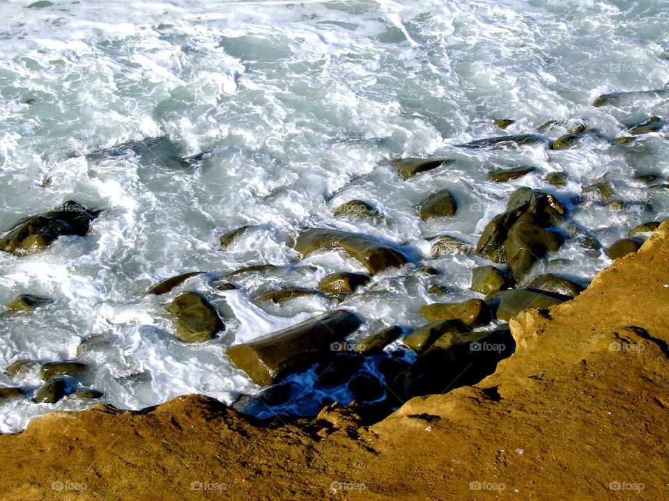 water rocks bank waves by refocusphoto