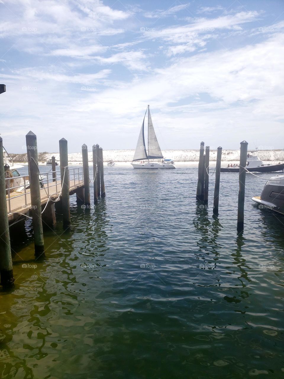 Harbor Walk Destin FL.  This is a virtual hub of tourist activity. There are wonderful restaurants, clever and unique boutiques, tattoos, jewelry, photography options, even a chance to find a pearl in an oyster!  Let the good times roll! Boat rides !