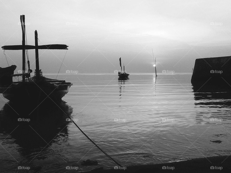 several canoes on the beach at sunrise